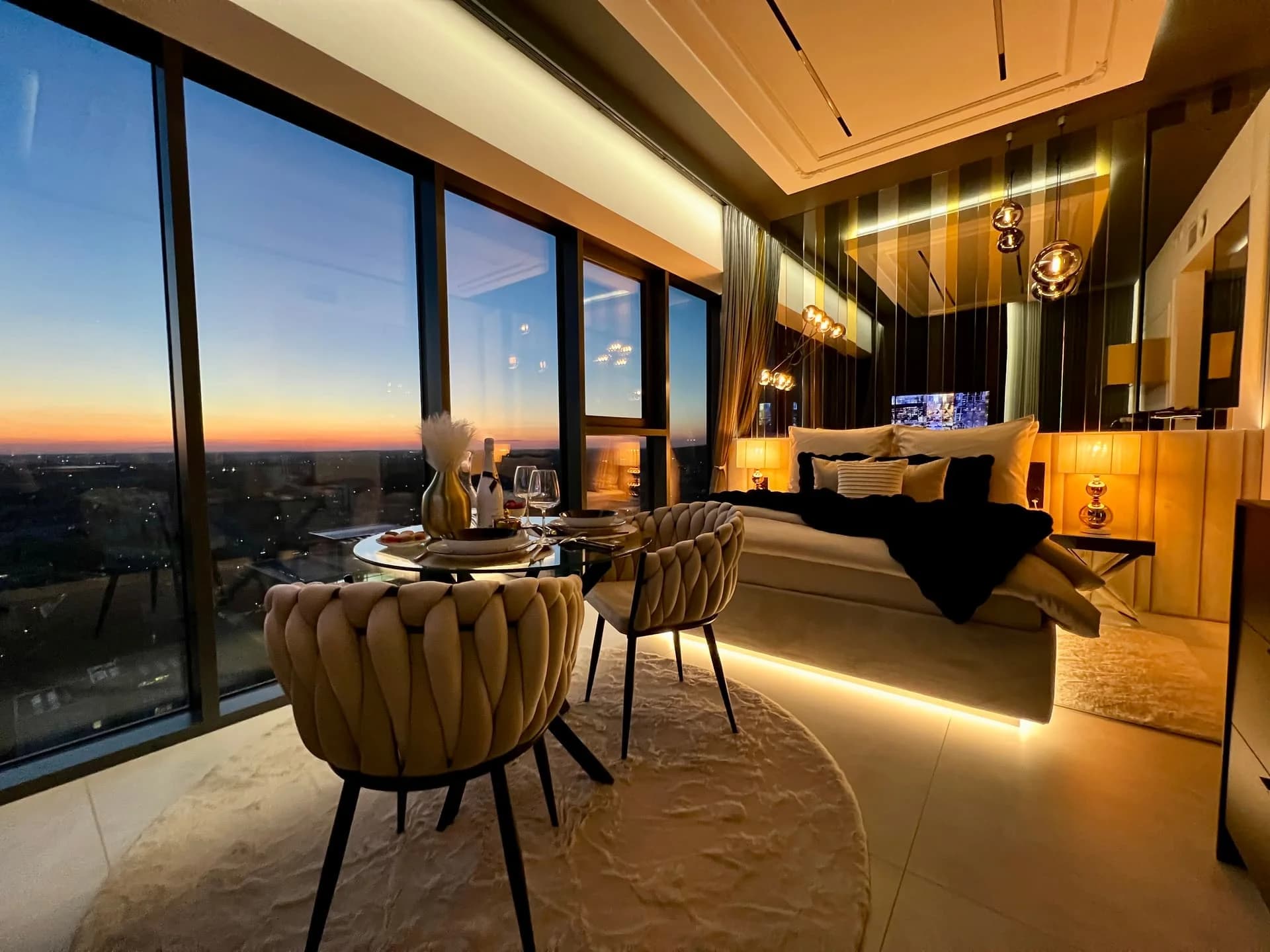 A designer interior with panoramic 22nd-floor city views, inside an iconic tower with indoor pool & wellness